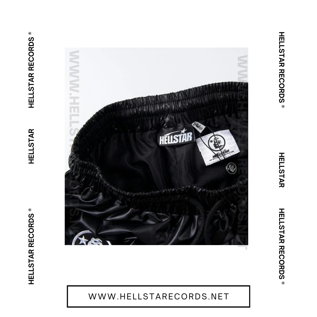 Close view of Hellstar Waxed Nylon Shorts in black with silver graphic logo