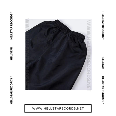 Close view of Hellstar Waxed Nylon Shorts with white drawstring on black fabric