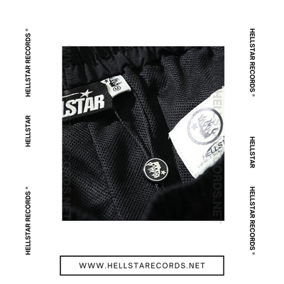 Close view of Hellstar Waxed Nylon Shorts with bold pink graphic on black fabric