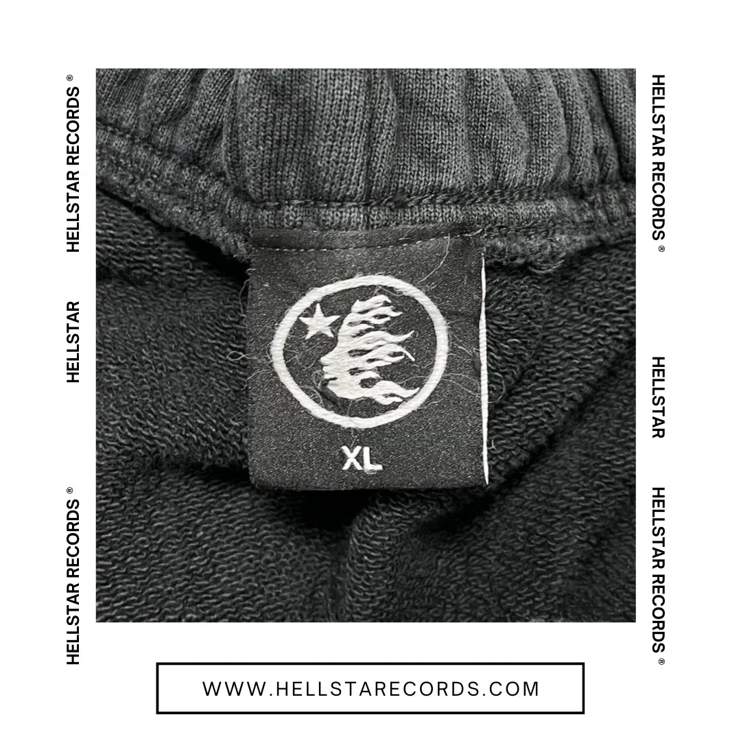 Tag view of the Hellstar Records Flame Flare Sweatpants in black, featuring white flame graphics and the Hellstar Records logo.

